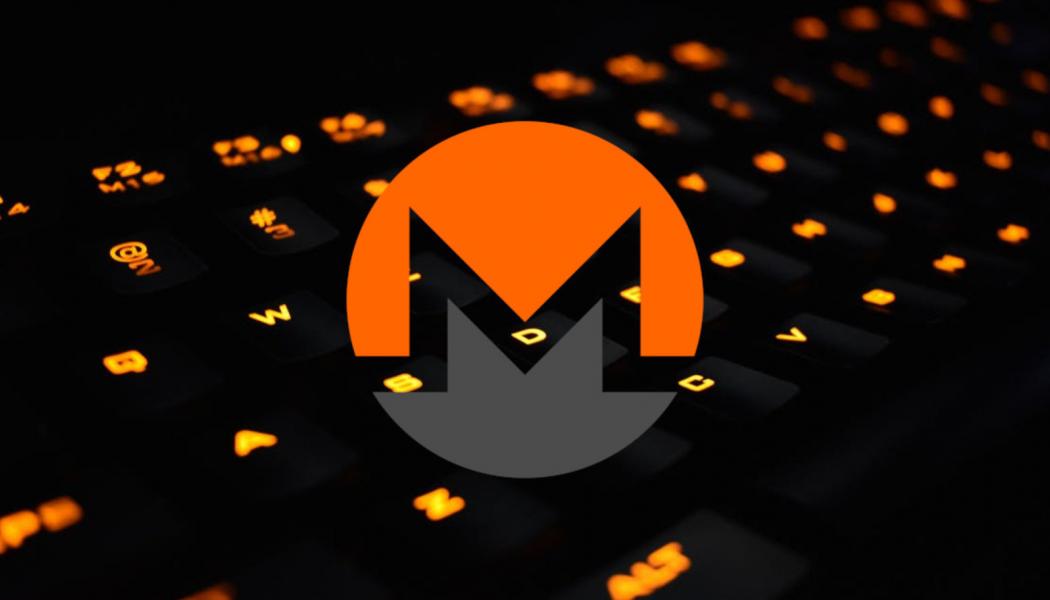 Monero Logo over orange-lighted laptop keyboard